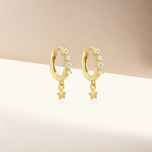 Close-up of gold S925 silver star hoop earrings with clear sparkling gemstones