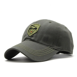 Close-up of tactical cotton baseball cap with shield embroidery and olive camouflage texture