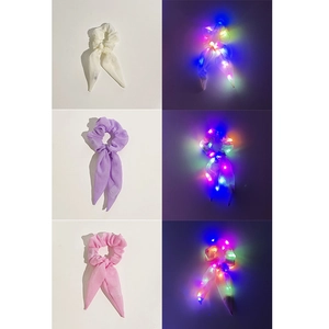 Detail of LED glowing hair scrunchies in white, purple and pink chiffon with ribbons