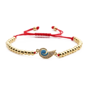 Gold-plated braided bracelet with blue enamel charm and sparkling zircon accents