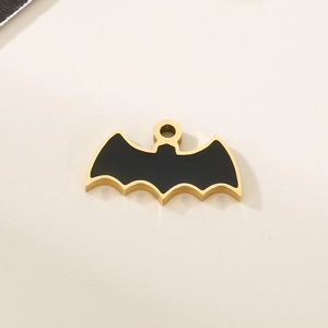 Detailed view of a gold and black bat-shaped pendant with smooth enamel finish and loop