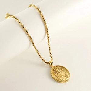 Macro view of 18K gold-plated stainless steel Jesus Christ oval relief pendant necklace