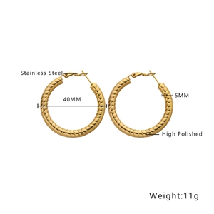 Macro shot of gold-plated twisted hoop earrings showing 40mm diameter and 5mm thickness