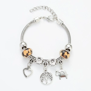 Detail of silver snake chain bracelet with Tree of Life, heart and elephant charms