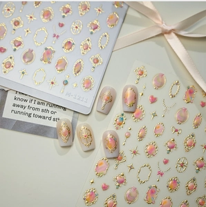 Macro shot of Baroque style nail stickers M-1211 with gold relief and gem patterns
