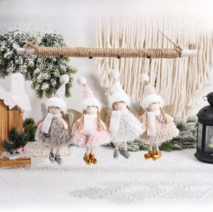 Detailed view of four colorful plush angel girl ornaments hanging on a rustic wooden bar