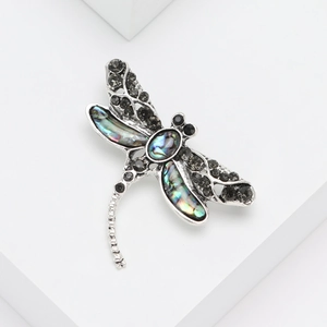 Silver dragonfly brooch with colorful abalone shell wings and black sparkling rhinestones