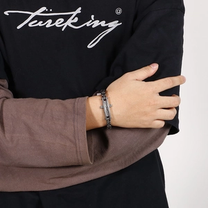 Close-up of industrial style bicycle chain bracelet in gunmetal finish on male wrist