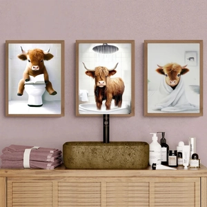Detail of whimsical highland cow triptych canvas prints in a pink themed bathroom