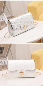 Detail of woven texture PU leather crossbody bag with golden geometric twist lock