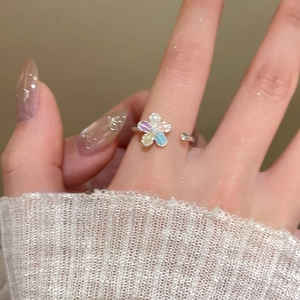 Close-up of elegant flower open ring with colorful petals and sparkling zircon accents