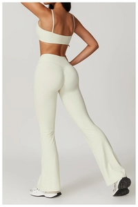 Detail of white high-waist flared yoga pants with supportive high-elastic performance fabric
