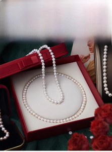Natural freshwater pearl necklace displayed in a red gift box with a silk rose