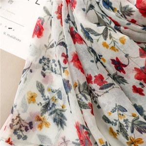 Close-up of floral print voile scarf showing lightweight fabric texture and red flower pattern