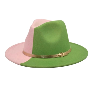 Detail of a two-tone pink and green fedora hat with a gold metal buckle strap