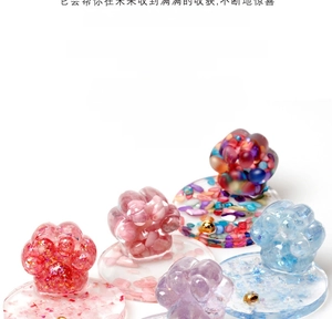 Macro detail of handmade cat paw resin ornaments with natural crystal stones