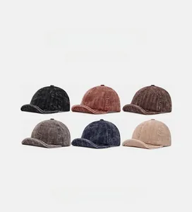 Close-up of vintage corduroy baseball caps in six assorted colors showing fabric texture