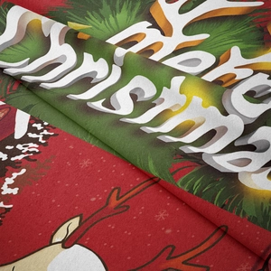 Macro shot of soft Merry Christmas tapestry fabric with reindeer motif and fine stitching