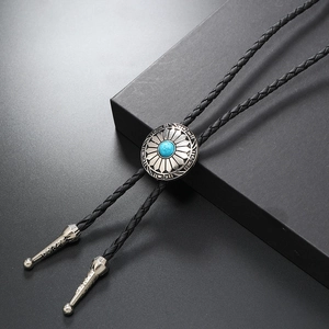 Detail of silver bolo tie with turquoise stone and black braided leather cord