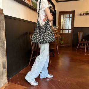 Floral cotton tote bag with green heart pattern shown as a vintage shoulder bag style
