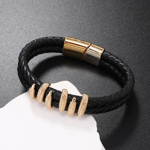 Detail of black braided leather bracelet with golden rings and magnetic clasp