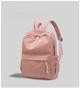 Pink corduroy backpack close-up showing vertical stripe texture and knot zipper pull details