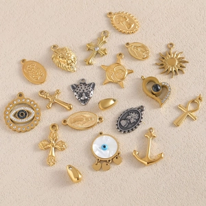 Assorted gold and silver stainless steel pendants with cross, sun, and evil eye designs