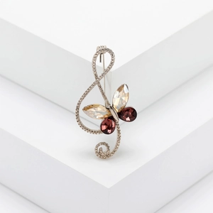 Elegant silver musical note brooch with butterfly crystal wings and sparkling rhinestones