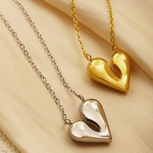 Polished gold and silver irregular puffy heart pendant necklaces on silk fabric
