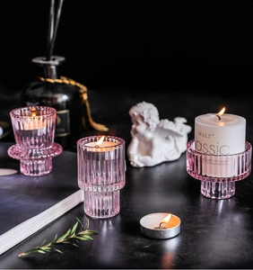 Detailed view of pink ribbed glass candle holders with elegant vertical prism texture