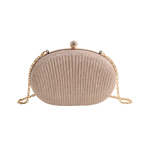 Champagne gold evening clutch with sequins, radial texture, and rhinestone ball clasp
