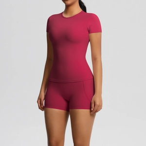 Detailed close-up of dark rose nylon yoga set with curved stitching on sports shorts