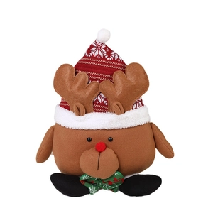 Brown Christmas reindeer plush toy wearing a red snowflake hat and green plaid bowtie