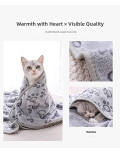 Detail of gray flannel pet blanket with paw prints showing soft fabric and cozy cat use