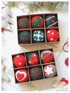 Detailed view of handmade felt Christmas ornaments in a gift box with a rustic setting