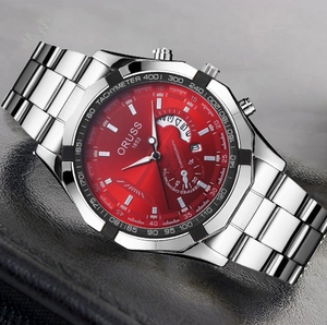 Macro shot of red dial chronograph watch with octagonal bezel and steel strap