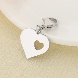 Polished heart-shaped hollow pendant with lobster clasp on a minimalist texture