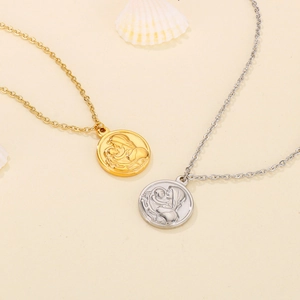 Vintage stainless steel round pendant necklace with Virgin Mary relief on beige background