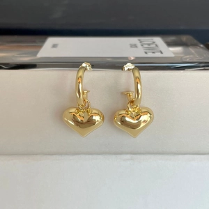 Close-up of gold S925 sterling silver hoop earrings with 3D puffy heart pendants