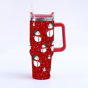 Detail of red 40oz Christmas tumbler with festive snowman and snowflake patterns