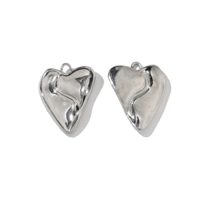 Detailed view of silver heart charms with irregular liquid metal texture for DIY jewelry