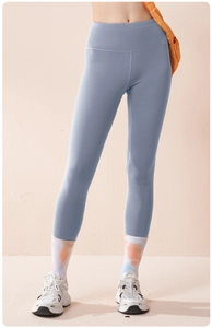 Detail of high waist yoga pants in dusty blue with flatlock stitching and soft texture