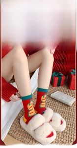 Close-up of red cotton festive socks with yellow dragon pattern and ribbed cuff detail