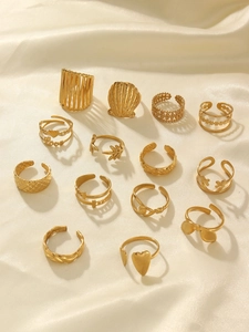 Close-up of 13-piece gold stainless steel ring set with heart and shell charms