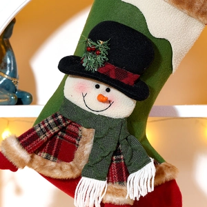 Classic plush snowman Christmas stocking with knitted scarf hanging in warm festive lighting