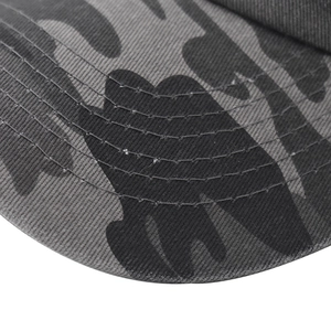 Detailed macro view of the camouflage baseball cap brim with reinforced parallel stitching