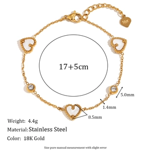 Detail view of 18K gold plated stainless steel bracelet with heart and round stone charms