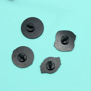 Detail view of the black metal brooch backings with rubber clutch fasteners set