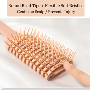 Pink curved scalp massage hairbrush with soft bristles and flexible rounded bead tips