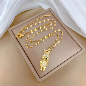 Detail of gold titanium steel necklace with crystal encrusted girl pendant in jewelry box